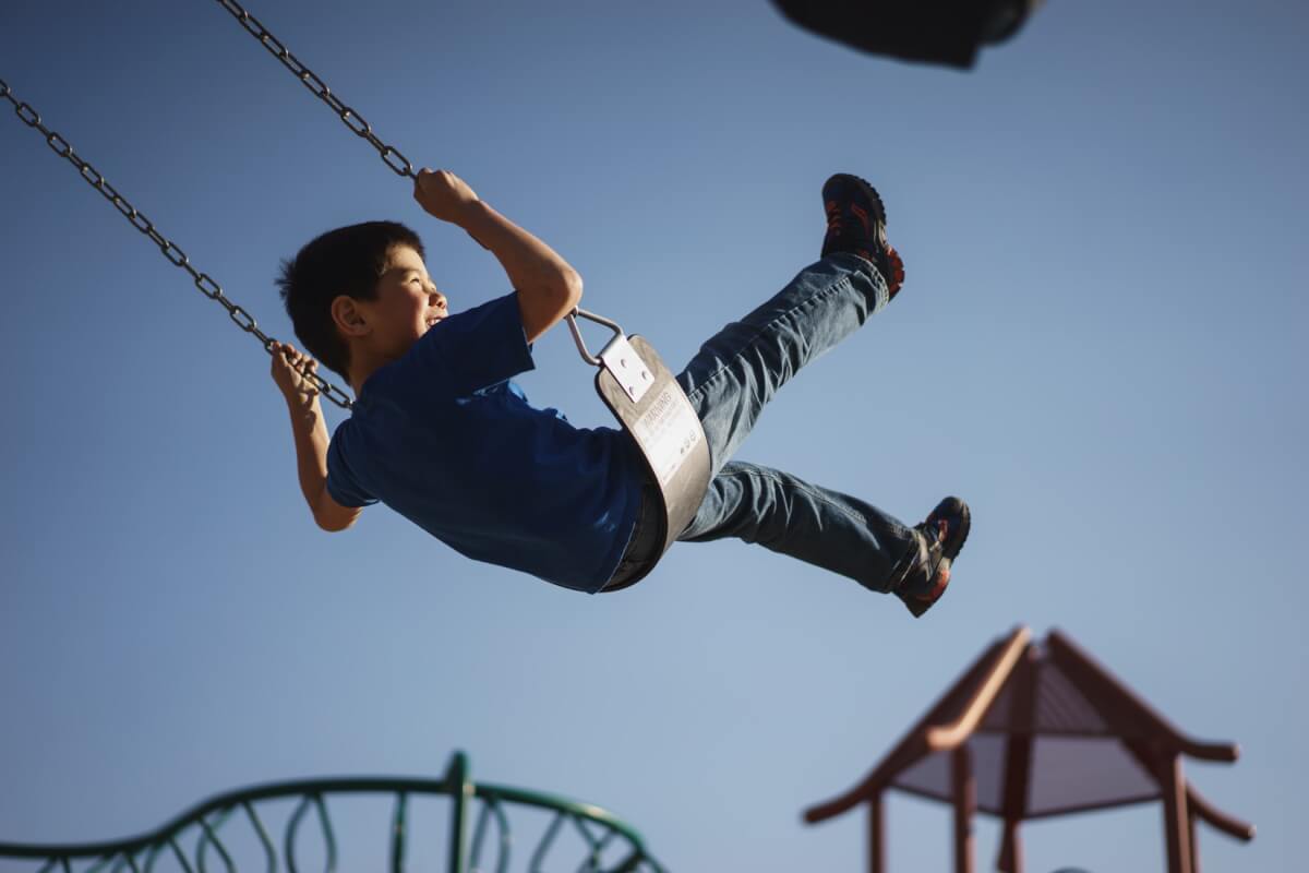 Image of a little boy on a swing.